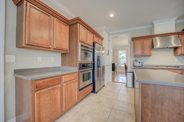 kitchen with appliances with stainless steel finishes, light tile patterned floors, crown molding, and wall chimney range hood