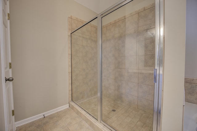 bathroom with tile patterned flooring and walk in shower