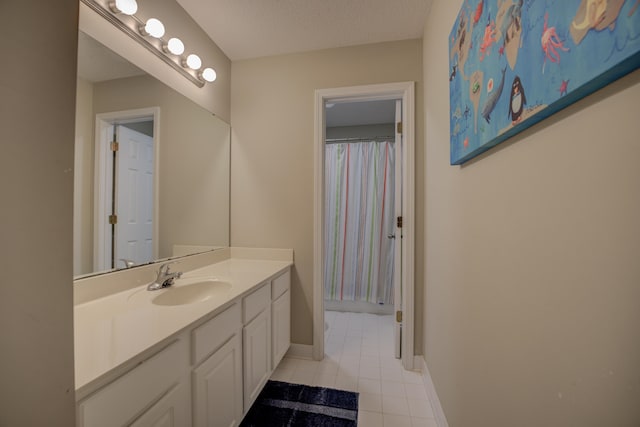 bathroom with a textured ceiling, vanity, tile patterned floors, and a shower with curtain