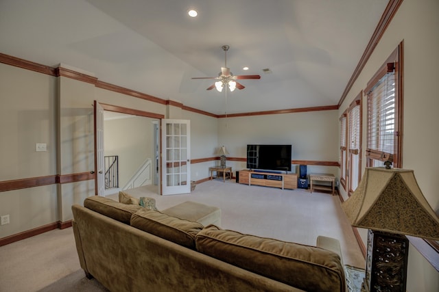 carpeted living room featuring french doors, ceiling fan, and crown molding