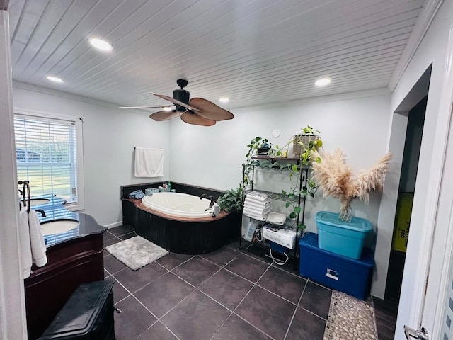 bathroom with ceiling fan, a washtub, tile patterned floors, crown molding, and vanity