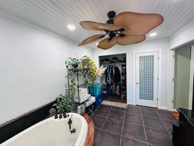 bathroom with tile patterned floors, a bathtub, wooden ceiling, and crown molding