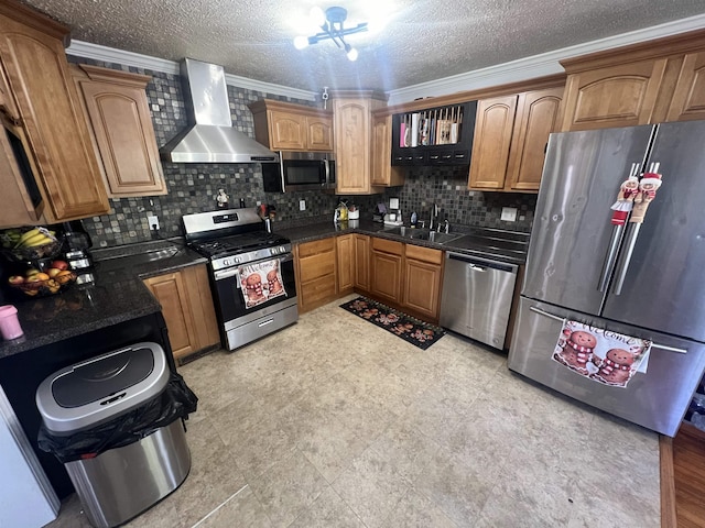 kitchen featuring wall chimney exhaust hood, ornamental molding, stainless steel appliances, and tasteful backsplash