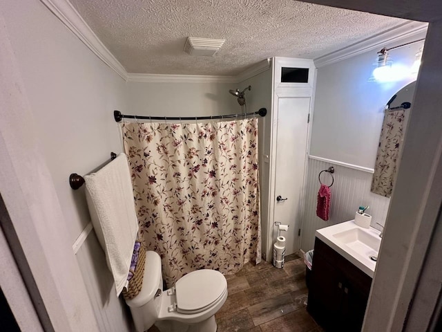 bathroom featuring hardwood / wood-style floors, a textured ceiling, toilet, vanity, and ornamental molding