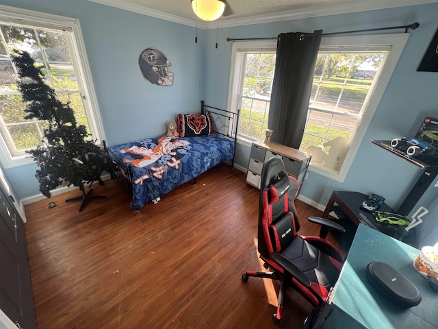 bedroom with crown molding and dark hardwood / wood-style floors