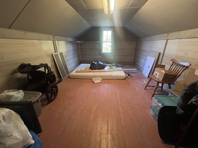 bonus room with hardwood / wood-style flooring, vaulted ceiling, and wood walls