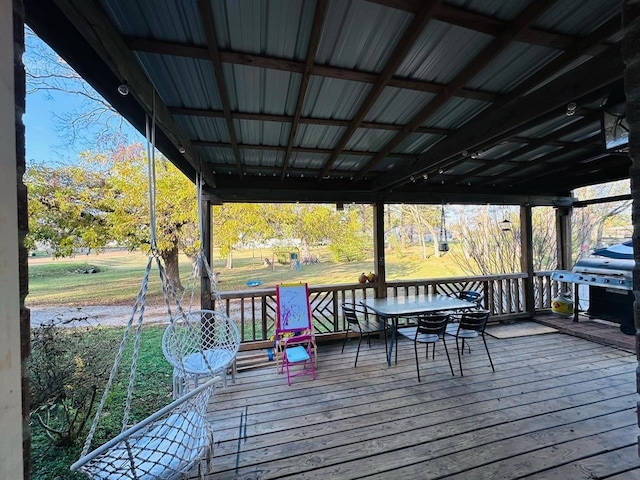 wooden terrace featuring a yard and area for grilling