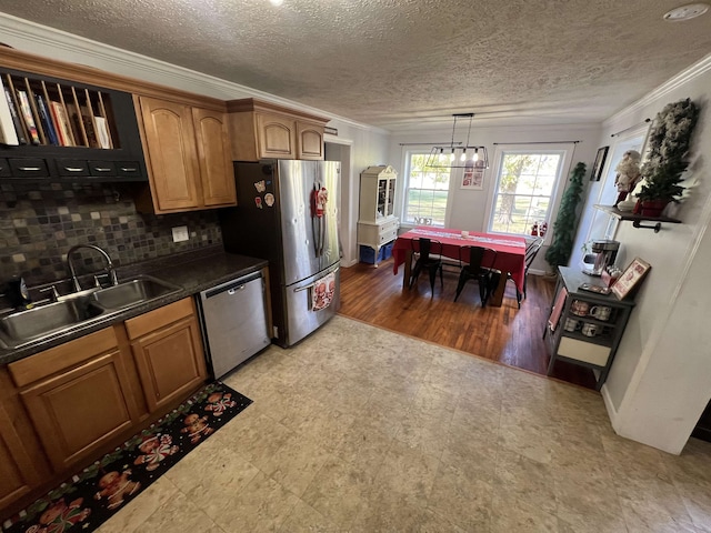 kitchen featuring sink, tasteful backsplash, hardwood / wood-style floors, pendant lighting, and appliances with stainless steel finishes