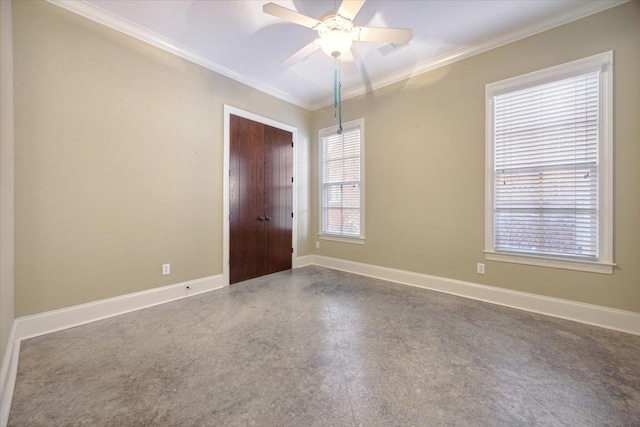 spare room with ceiling fan and crown molding