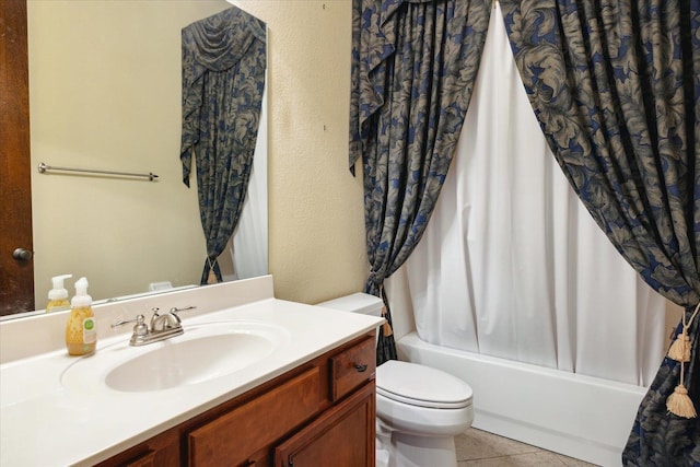 full bathroom featuring tile patterned floors, vanity, toilet, and shower / bath combo with shower curtain