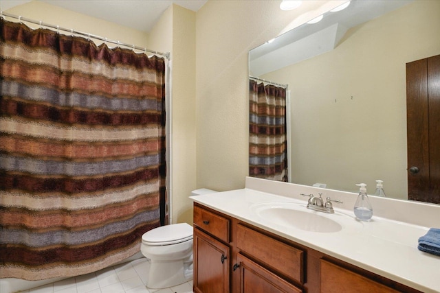 bathroom with tile patterned floors, vanity, and toilet