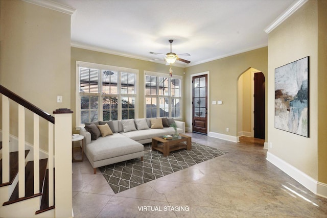 living room featuring ceiling fan, a healthy amount of sunlight, and crown molding