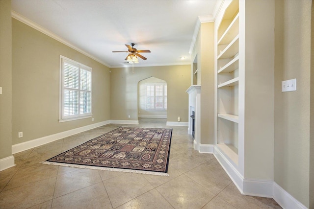 unfurnished living room with crown molding, built in features, ceiling fan, and light tile patterned floors