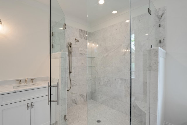 bathroom with vanity and a shower with door