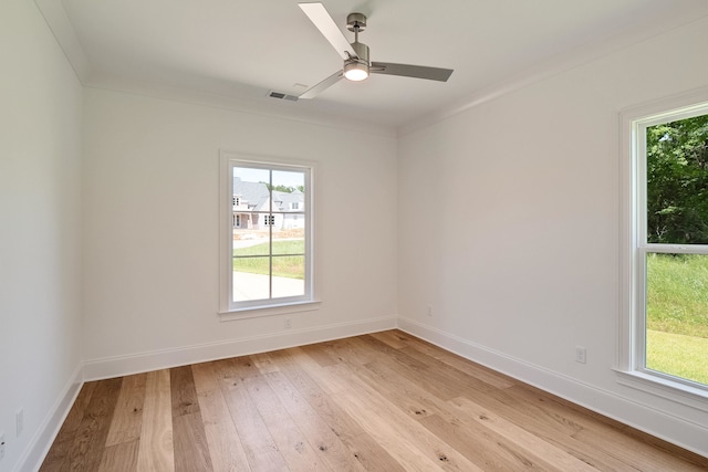 unfurnished room with ceiling fan, light wood-type flooring, and ornamental molding