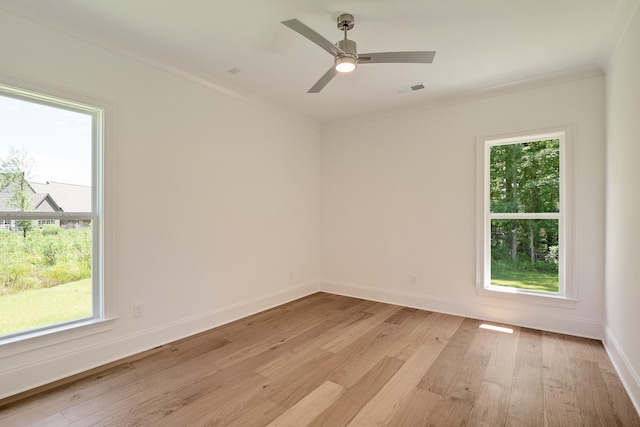 spare room with light hardwood / wood-style flooring, plenty of natural light, crown molding, and ceiling fan