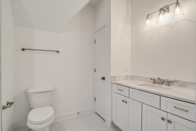 bathroom featuring tile patterned flooring, vanity, and toilet