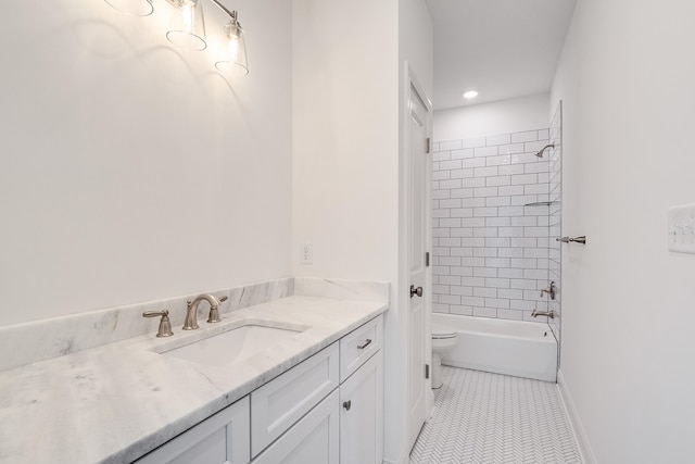 full bathroom with tile patterned flooring, vanity, tiled shower / bath combo, and toilet