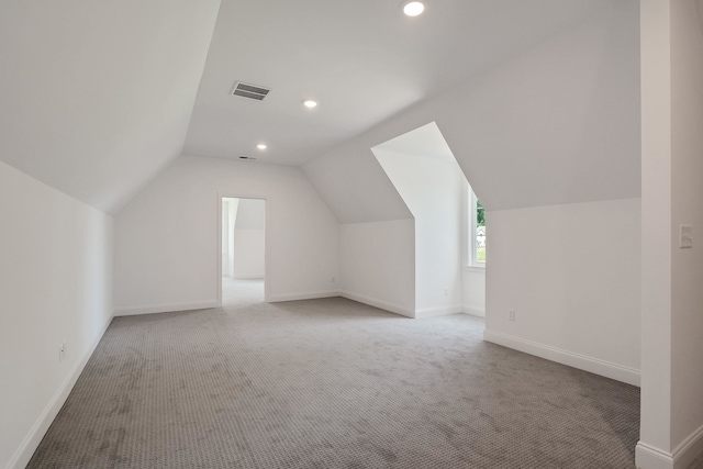 additional living space with carpet floors and lofted ceiling