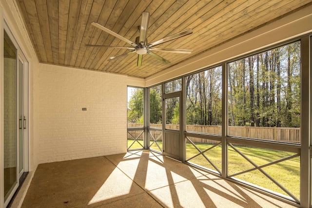 unfurnished sunroom with ceiling fan and wood ceiling