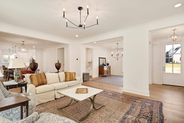 living room with light wood-type flooring and ornamental molding