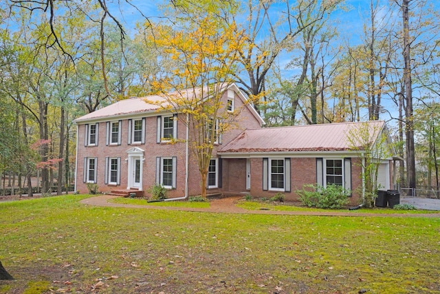 colonial-style house with a front yard and a garage