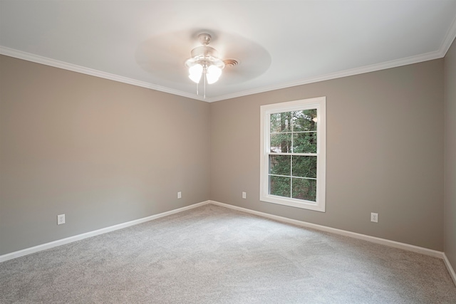 carpeted spare room featuring crown molding and ceiling fan