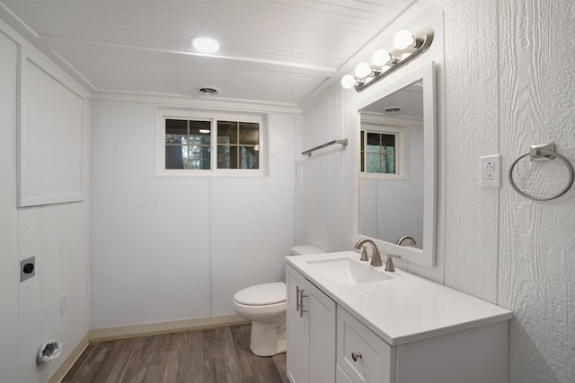 bathroom featuring wood-type flooring, vanity, and toilet