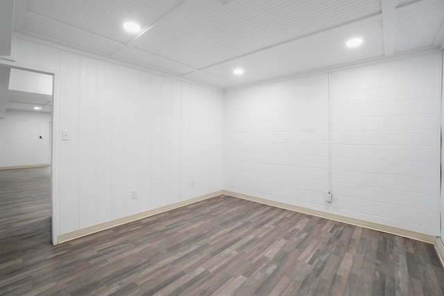 unfurnished room featuring wooden walls and dark hardwood / wood-style flooring