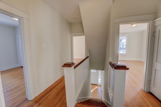 stairs featuring ornamental molding and hardwood / wood-style flooring