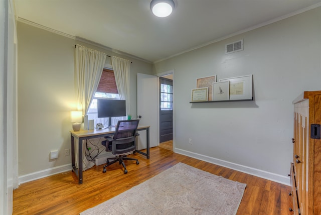 office area with hardwood / wood-style floors and crown molding