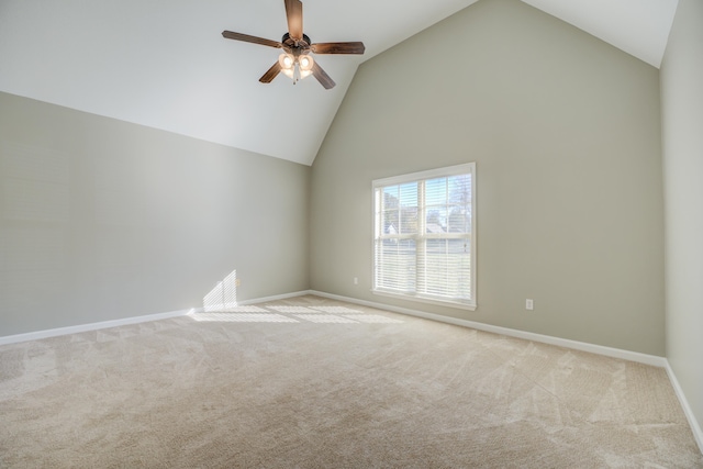 carpeted spare room featuring vaulted ceiling and ceiling fan