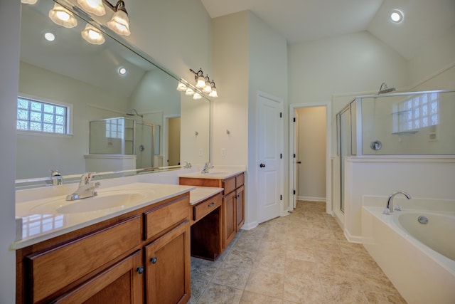 bathroom with tile patterned floors, vanity, high vaulted ceiling, and separate shower and tub