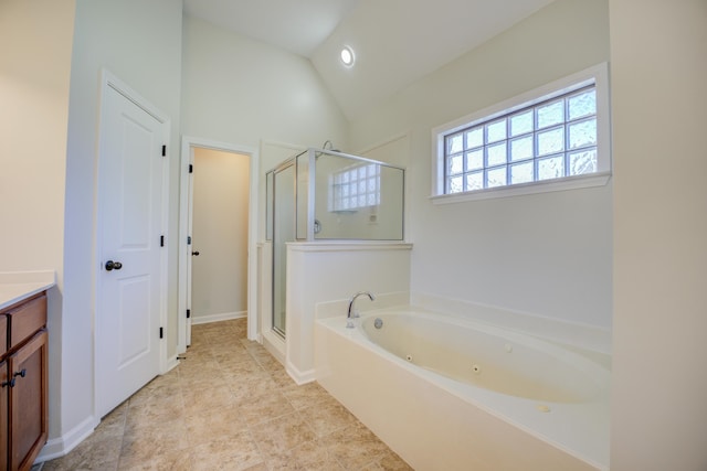 bathroom with tile patterned floors, plus walk in shower, vanity, and lofted ceiling