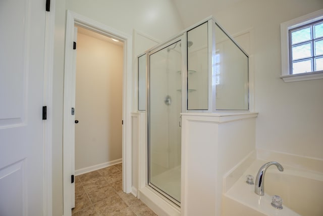 bathroom with tile patterned floors and separate shower and tub