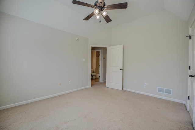 carpeted empty room featuring ceiling fan and lofted ceiling