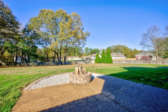 view of yard featuring a patio and an outdoor fire pit