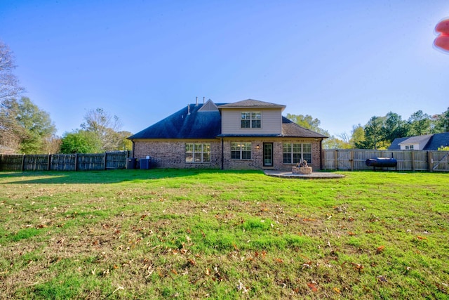 rear view of property with a yard and a patio