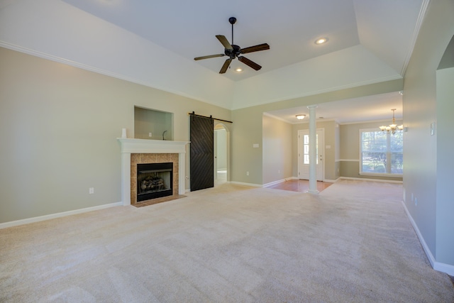 unfurnished living room featuring ceiling fan with notable chandelier, a barn door, crown molding, and light carpet