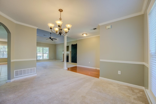 carpeted spare room with crown molding and ceiling fan with notable chandelier