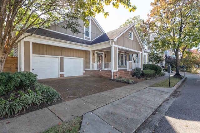 craftsman house featuring covered porch and a garage