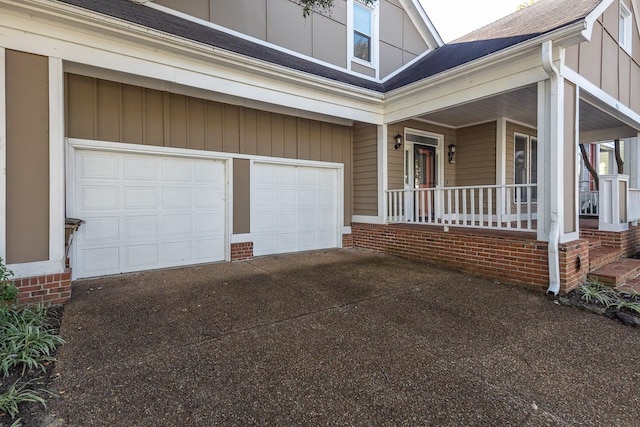 exterior space with a porch and a garage