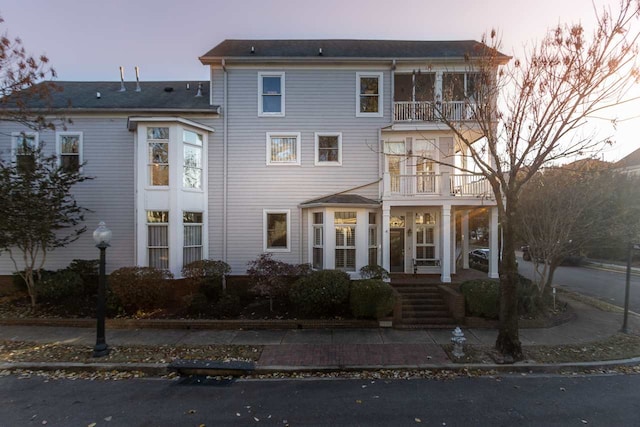 view of front of house featuring a balcony