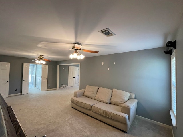 carpeted living room featuring ceiling fan