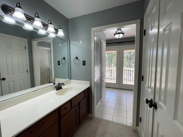 bathroom featuring french doors, vanity, tile patterned floors, and an enclosed shower