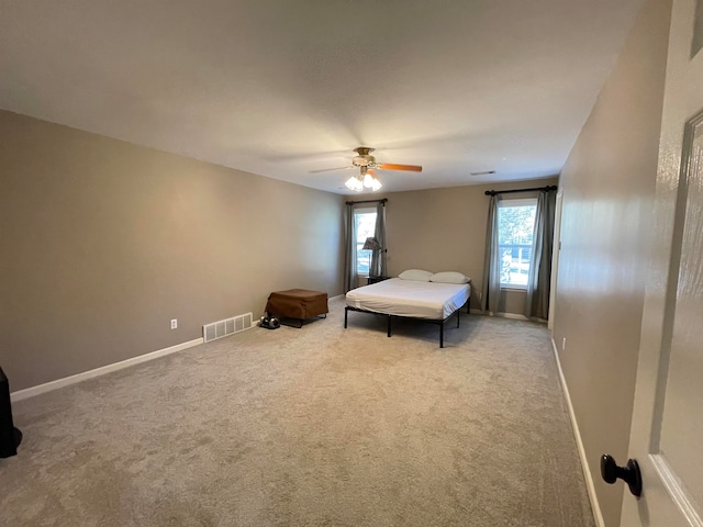 unfurnished bedroom featuring ceiling fan and carpet