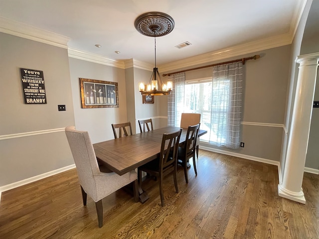 dining room with a chandelier, dark hardwood / wood-style flooring, decorative columns, and ornamental molding