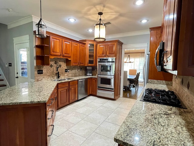 kitchen featuring pendant lighting, light stone counters, ornamental molding, and stainless steel appliances