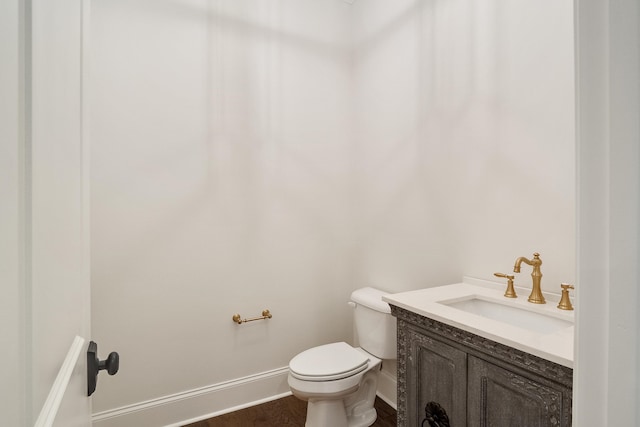 bathroom featuring hardwood / wood-style flooring, vanity, and toilet