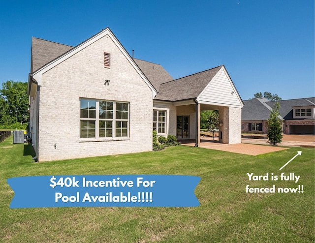 140 Magnolia Ridge Dr, Rossville, TN 38066 - back of property with central AC unit, brick siding, a yard, a patio, and a shingled roof